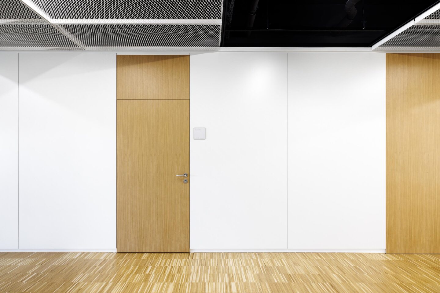 KNF Neuberger GmbH | front view of system wall with wooden door