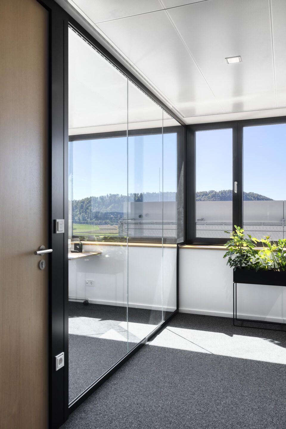 Rheinhalde Development | hallway with glass wall and view of the outside scenery