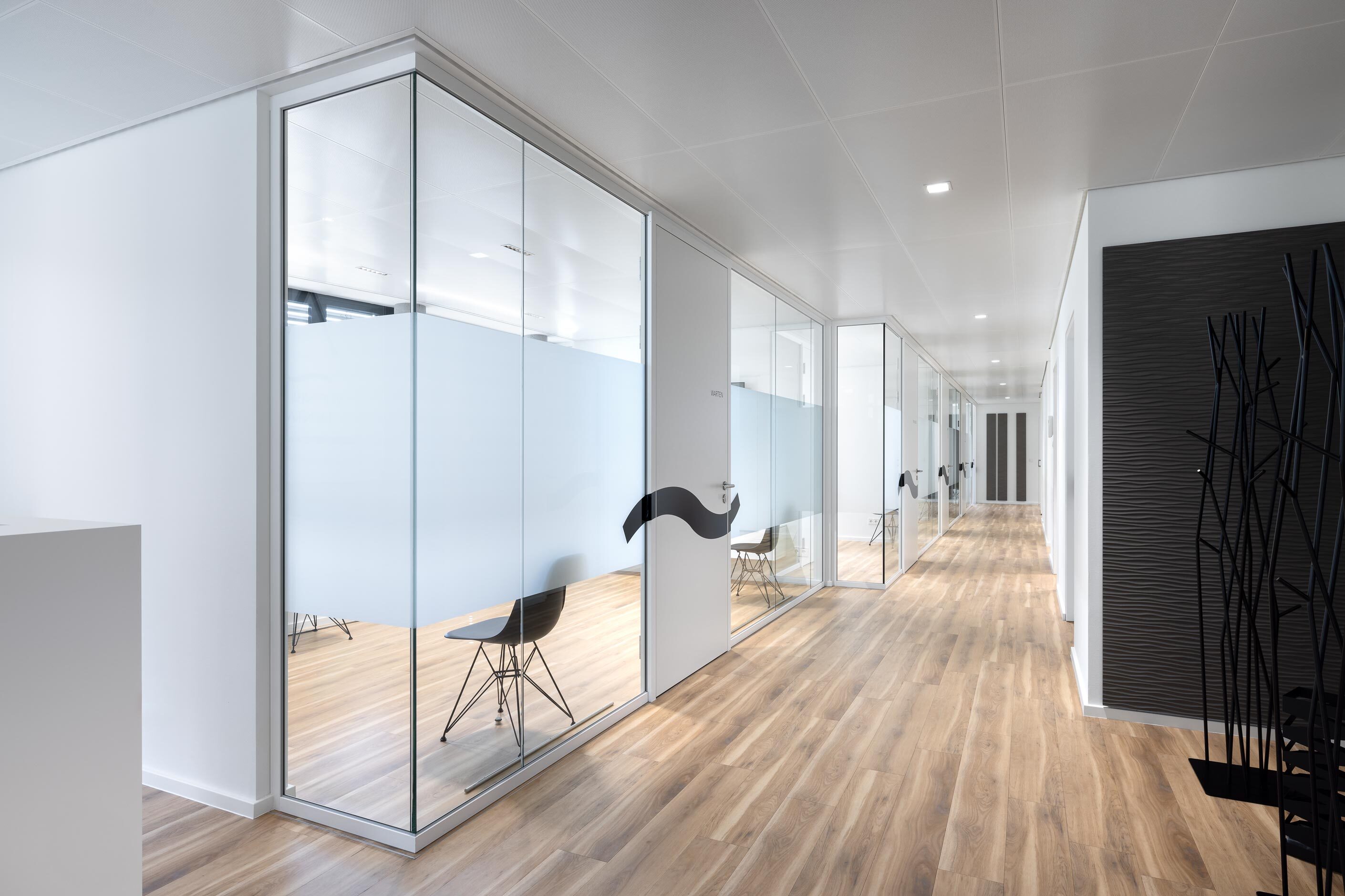Rheinhalde Development | rooms of the dental practice separeted by glass walls