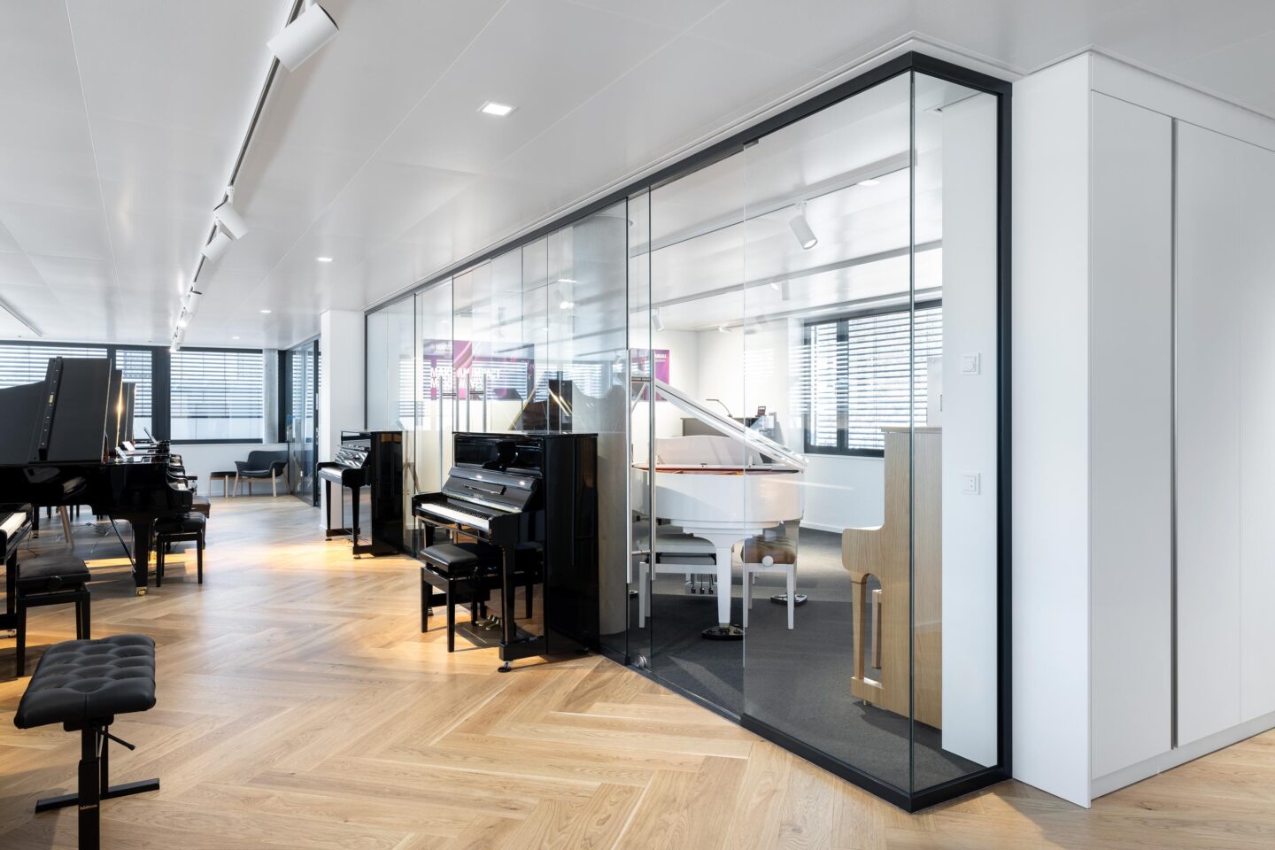 Rheinhalde Development | piano store hallway with pianos