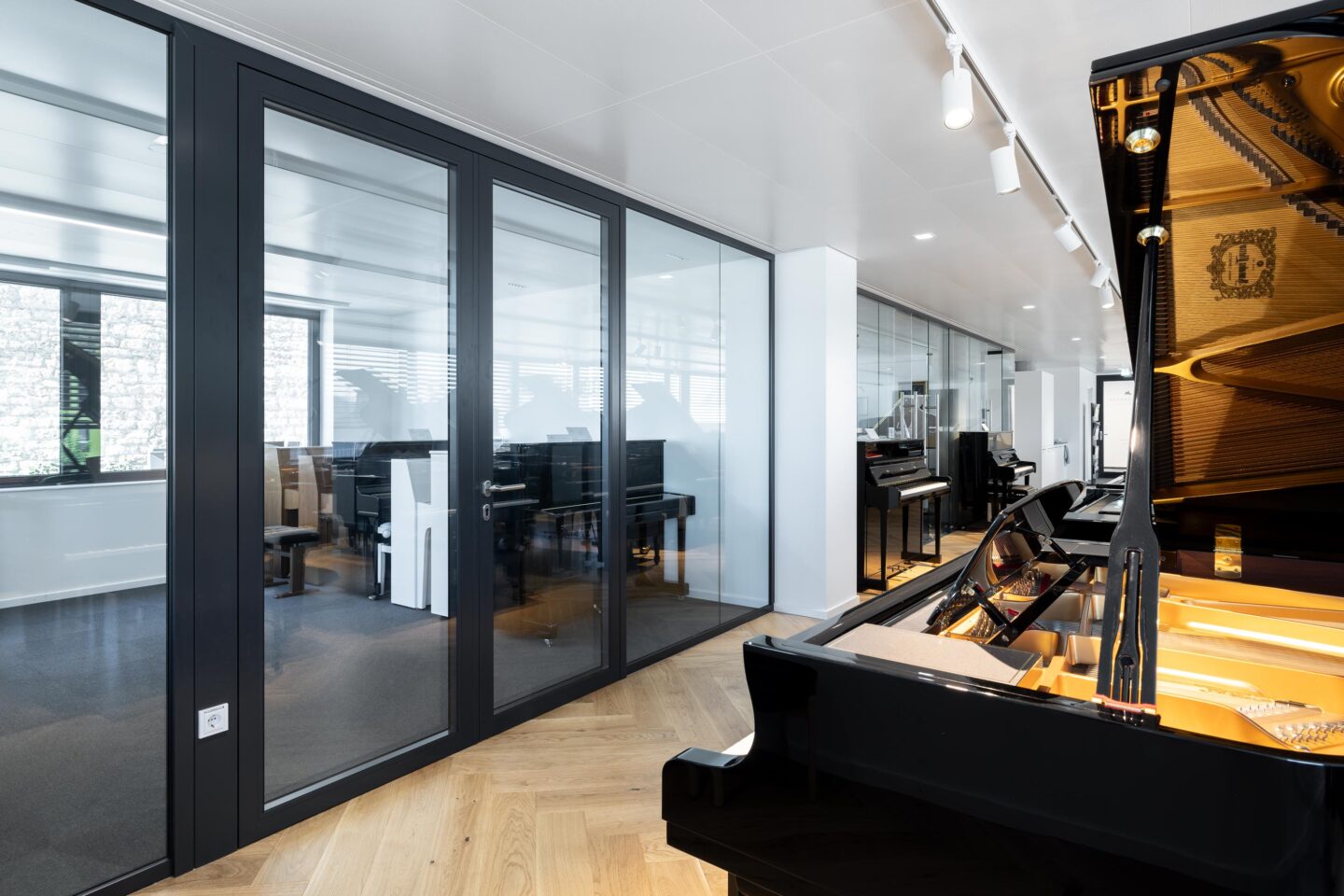 Rheinhalde Development | piano store with glass walls