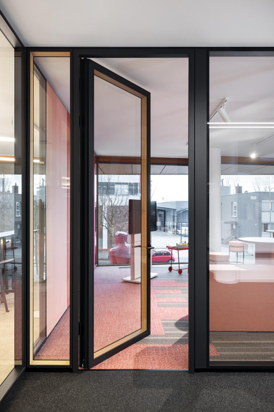Open glass system door with wooden frame in the office | Modular partition walls and office furniture by feco for feco-forum Karlsruhe